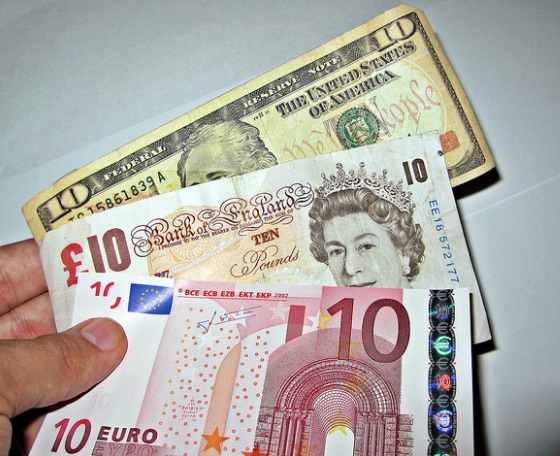 currency_exchange___a_person_holding_three_different_foreign___flickr